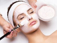 Woman Receiving  Facial Mask In Spa Beauty Salon