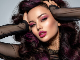 Wall Mural - portrait of beautiful young woman with bright maroon makeup. beautiful brunette with bright cherry l