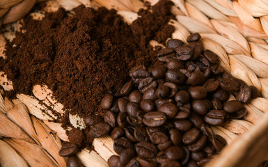 Wall Mural - Close up view of a coffee set-up - fresh beans and ground coffee on a mat basket