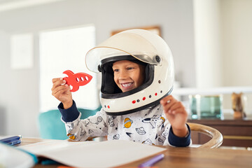 child playing with astronaut helmet and rocket