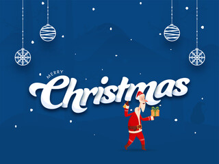 Wall Mural - Merry Christmas Font with Cartoon Santa Claus Holding Gift Box, Jingle Bell and Hanging Baubles on Blue Background.