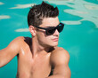 © vladorlov - Summer. Young attractive guy in the pool.