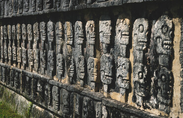 Wall Mural - Wall with carved skulls in a Mayan temple in Chichen Itza, Yucatan, Mexico