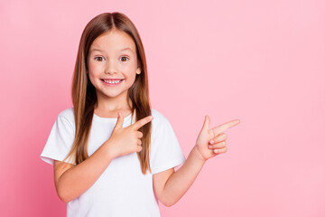 Close-up portrait of her she nice attractive lovely sweet glad cheerful cheery girl pointing two forefingers look idea choose choice copy space isolated pink pastel color background