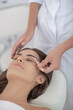 © zinkevych - Beautiful woman having procedure of eyebrows dying