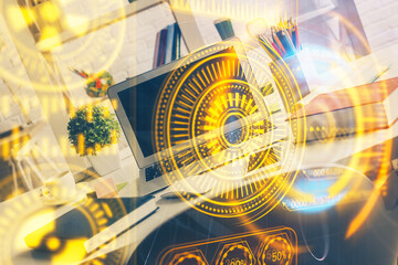 Computer on desktop in office with technology theme hologram. Double exposure. Tech concept.