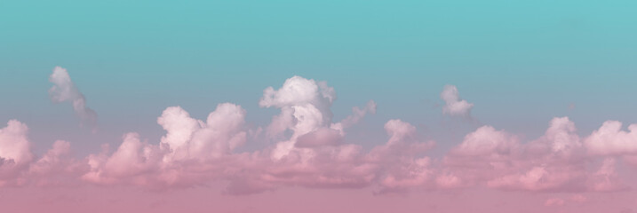 Wall Mural - Blue-pink sky panorama. White air clouds on a blue sky background.