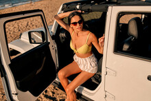 Woman With Car On Beach