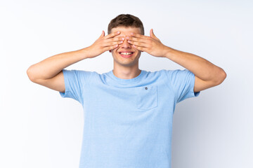 Wall Mural - Young handsome man over isolated white background covering eyes by hands