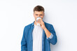 © luismolinero - Young handsome man over isolated white background holding and drinking a coffee to take away