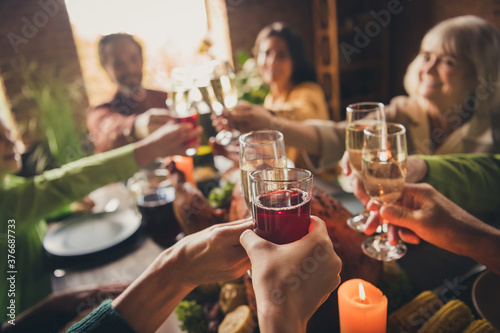 Portrait of nice attractive family sitting around served table clinking glasses celebratory good mood every year cozy festive at modern loft industrial wooden interior house apartment