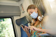Young woman travelling by train, wearing face mask