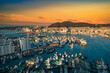 © nuttawutnuy - Busan skyline and pier at sunset in Busan, South Korea.