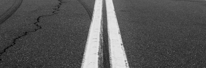 Asphalt background with two white road lines. Road markings on asphalt