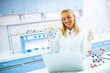 © BGStock72 - Happy female researcher in white lab coat using laptop while working in the laboratory