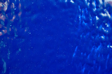 Freshly painted surface of blue paint close-up