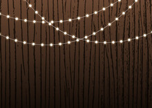Festive Background For Banner Or Presentation Or Greeting Card With Shiny String Lights Or Garlands On Wooden Texture Or Fence.