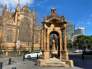 Wall Mural - Sandstone Frazer Memorial Fountain, Sydney. The public drinking fountain was a gifted to the city by John Frazer. Saint Mary's Cathedral in background