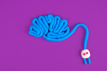 Poster - A human brain with a plug attached. Concept of brain activity on a lilac background. The concept of brainstorming. Stimulating mental activity. Charging for the brain.
