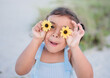 © Tamara Sales  - Little girl playing with flowers on the beach