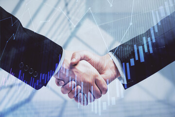 Double exposure of forex graph hologram and handshake of two men. Stock market concept.