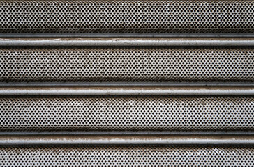 Perforated metallic surface texture background