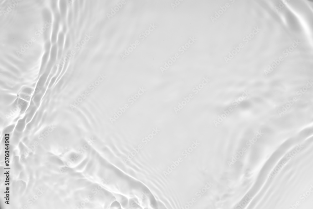Blurred desaturated transparent clear calm water surface texture with splashes and bubbles. Trendy abstract nature background. White-grey water waves in sunlight. Copy space. - obrazy, fototapety, plakaty 