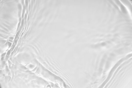 blurred desaturated transparent clear calm water surface texture with splashes and bubbles. trendy a