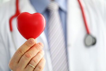 Sticker - Male medicine doctor hands holding and covering red toy heart