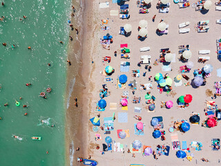 Wall Mural - Aerial View Of People And Colorful Umbrellas On Ocean Seaside Beach In Summer