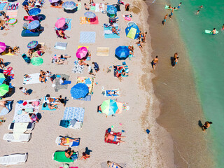 Wall Mural - Aerial View Of People And Colorful Umbrellas On Ocean Seaside Beach In Summer