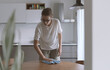 © stokkete - Woman cleaning the kitchen table with a cloth