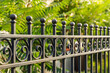 Beautiful decorative cast metal wrought fence with artistic forging. Iron guardrail close up.