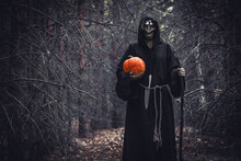 Woman Devil Ghost Demon Costume Horror And Scary She Holding Pumpkin In Hand In The Forest. The Vampire Ghost People, Happy Halloween Day Concept