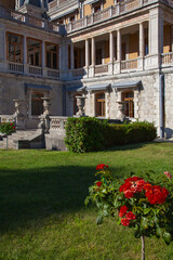 Wall Mural - Fragment of the facade of the ancient castle in Massandra (Crimea). There is a rose bush in the foreground