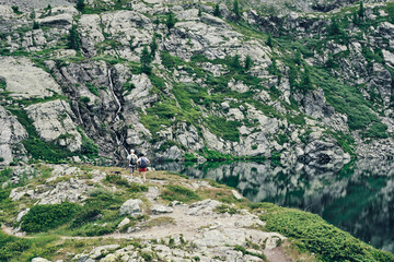 man and woman along path in mountain near the (Vercoche) lake - champorhcer - Aosta - Italy