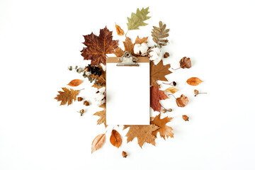 Wall Mural - Flat lay blank sheet clipboard with empty mockup copy space for text. Cotton buds, acorns, dry leaves on white background. Fall autumn styled template for social media, blog, magazine. Top view.