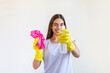 © Graphicroyalty - Young woman doing house chores holding cleaning tools. Woman wearing rubber protective yellow gloves, holding rag and spray bottle detergent. It's never too late to clean