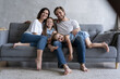 © opolja - Cheerful family at home sitting in sofa