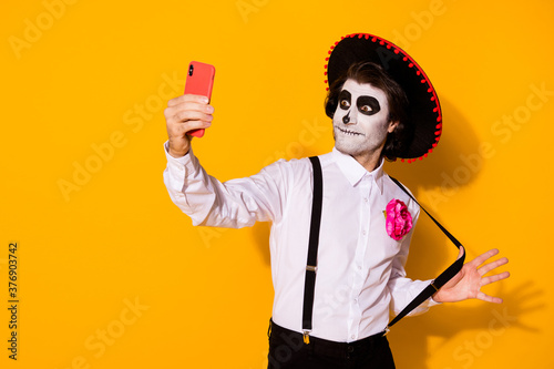 Fotomural Portrait of his he nice handsome painted spooky guy caballero taking making self