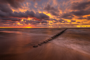 Wall Mural - sea landscape at sunset. beach, sea waves, breakwaters.