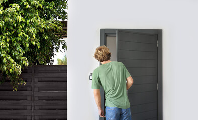 man opening the door of her home.inviting the guests.
