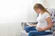 © pridannikov - Pregnant woman reads instructions and holds pills