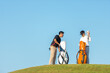 © freebird7977 - Group golfer asian two man approach on the tee off for swing and hitting golf ball and looking fairway in course. Hobby in holiday and vacations in sunny morning day on club golf.