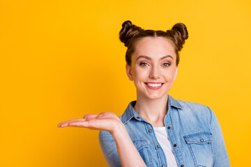 Canvas Print - Closeup photo of attractive pretty young teen lady two buns hold open arm novelty shopping product low price good quality offer wear casual denim shirt isolated yellow color background