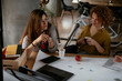 © JustLife - Businesswomen working on a new project. Colleagues discussing about problem they have to solved..