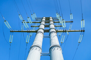 Close view onto structure of high voltage power pillar with its wires, transformers, etc