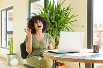 Wall Mural - young arab woman working at home with a laptop