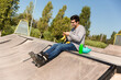 © Jordi Mora - roller boy eating a banana sitting in a skate park