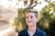 © Cavan Images - Portrait Of A Handsome Young Teen Looking Off And Smiling Outside